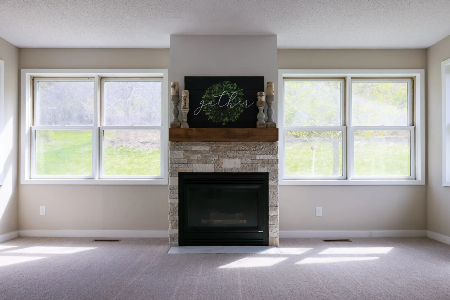 Freshly painted living room with fireplace, light neutral walls and white trim
